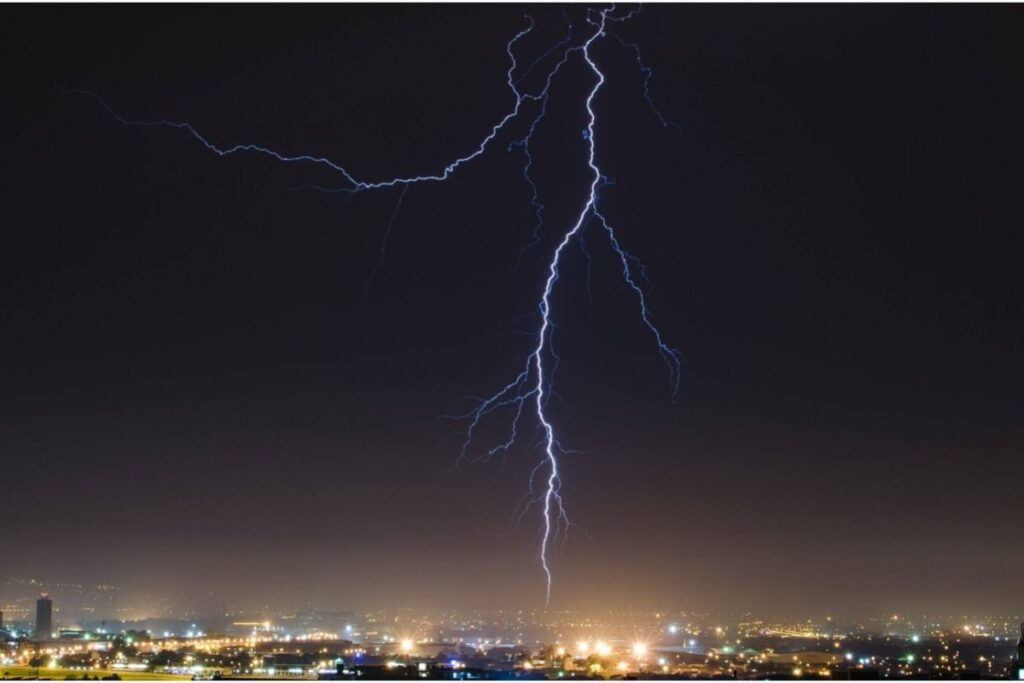 Lightning bolt across a dark sky during storm.