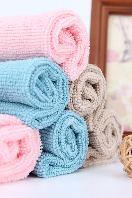 Stack of folded pink and blue towels.