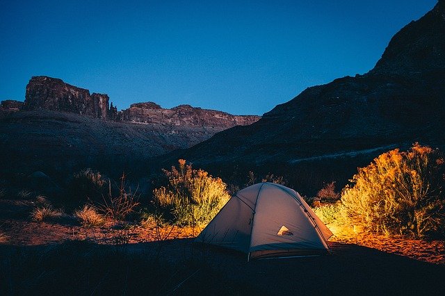 Tent camping outside in the mountains.